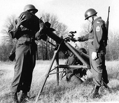 Soldiers in a field with a tripod mounted nuclear device