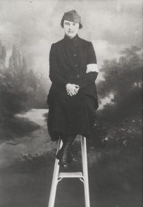 Cordelia Dupuis in uniform sitting on a stool.