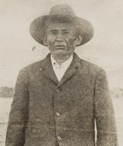 Elder Native man wearing a suit and hat. 