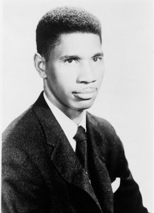Medgar Evers, head-and-shoulders portrait, facing right, wearing jacket and tie