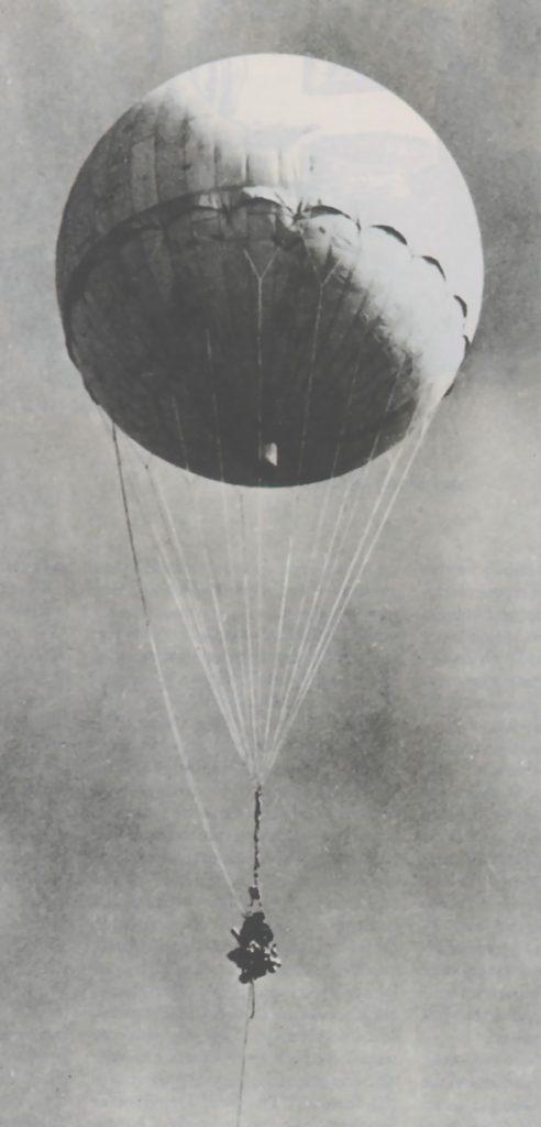 large balloon flying through the sky with a device hanging below it