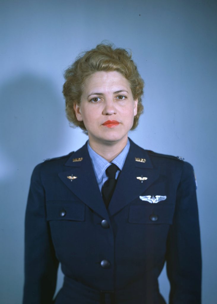 Woman in a blue dress uniform photographed from the waist up. 