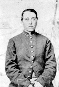 Albert Cashier, seated facing the camera, wearing Union Army coat. 