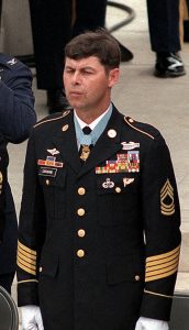 Jon Cavaiani stands in his dress uniform wearing his Medal of Honor. 