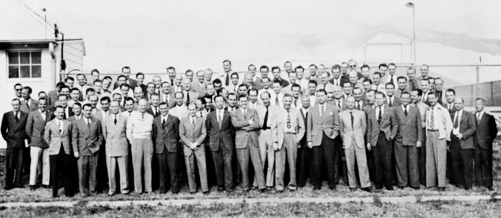 A large group of men pose for a picture. 