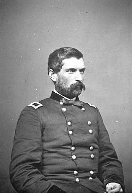 Man in Civil War uniform seated, looking to the right of the camera