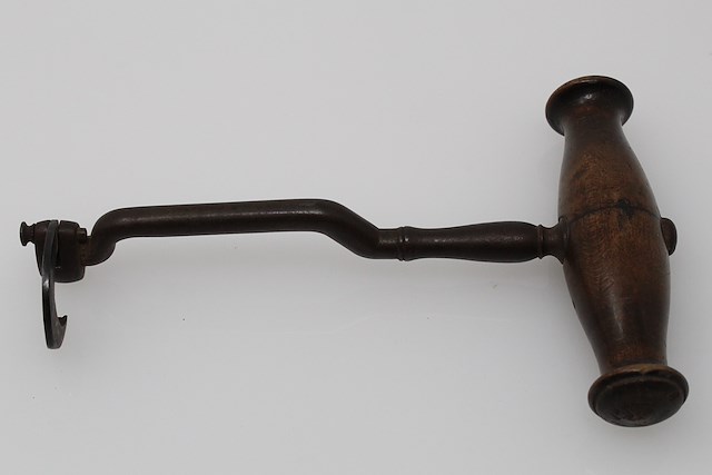 Iron tooth extractor with a wooden handle, also known as a dental key. Object ID MC390. Courtesy of The Fort Ticonderoga Museum Collection.