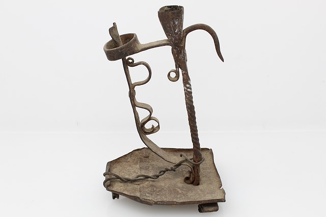Iron lamp designed to hold a single candle. Object ID FT-60.129. Courtesy of The Fort Ticonderoga Museum Collection.