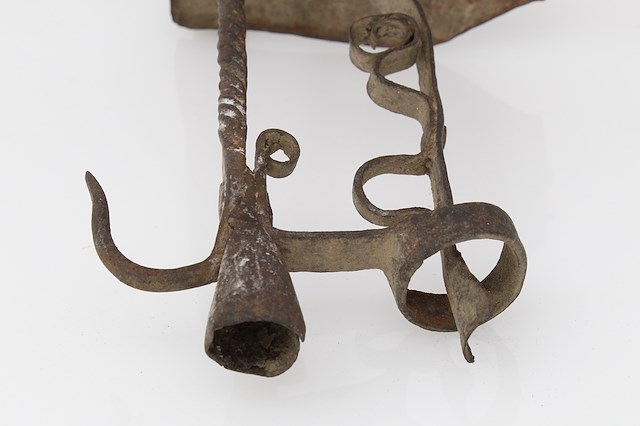 Iron lamp designed to hold a single candle. Object ID FT-60.129. Courtesy of The Fort Ticonderoga Museum Collection.