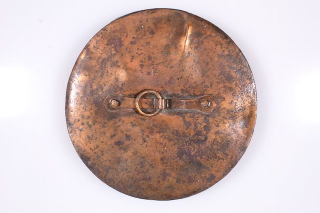 One copper alloy pot lid with lift ring and stamped makers mark. Found during the restoration of Fort Ticonderoga in the early 20th century. Object ID 2020.2.3. Courtesy of The Fort Ticonderoga Museum Collection.
