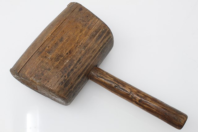 Mallet with wooden head and handle. The striking surfaces of the mallet head are angled. Object ID MC 528. Courtesy of The Fort Ticonderoga Museum Collection.