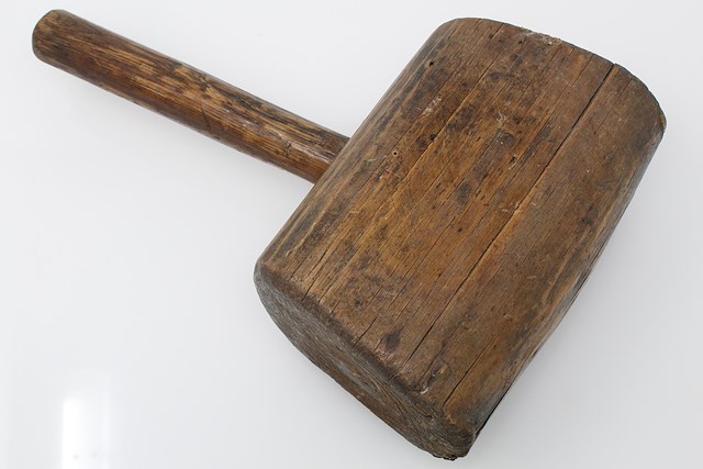Mallet with wooden head and handle. The striking surfaces of the mallet head are angled. Object ID MC 528. Courtesy of The Fort Ticonderoga Museum Collection.