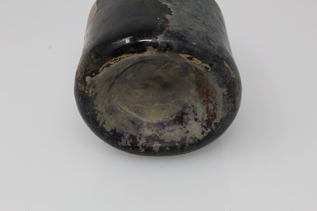 Dark green/brown glass bottle with some iridescence or patination on the surface. Object ID 2019.5.19. Courtesy of The Fort Ticonderoga Museum Collection.
