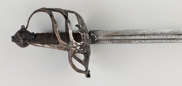 English basket-hilt “Mortuary” backsword with a straight single edged, double fuller 31.25″ blade. Object ID 2009.0098.043. Courtesy of the Fort Ticonderoga Museum Collection.