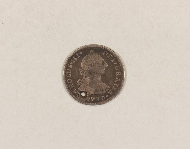 The coin valued at 1 reale was produced during King Charles III’s (1716-1788) reign. Object ID 2002.2.412.  Courtesy of the Fort Ticonderoga Museum Collection.
